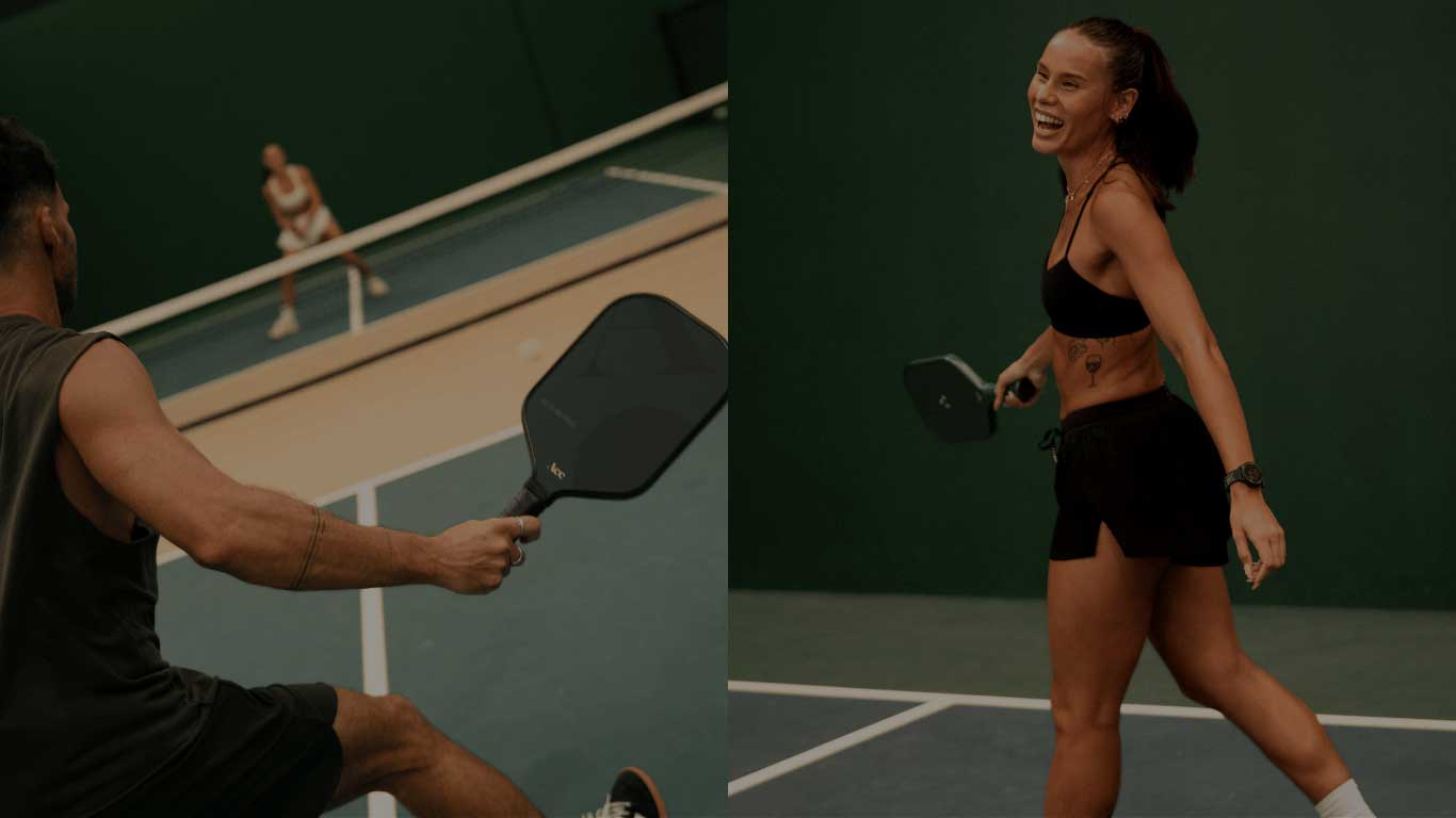 Two people playing pickleball on a court, with one person in the foreground and another in the background.